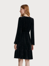 the back view of a lady in black midi dress